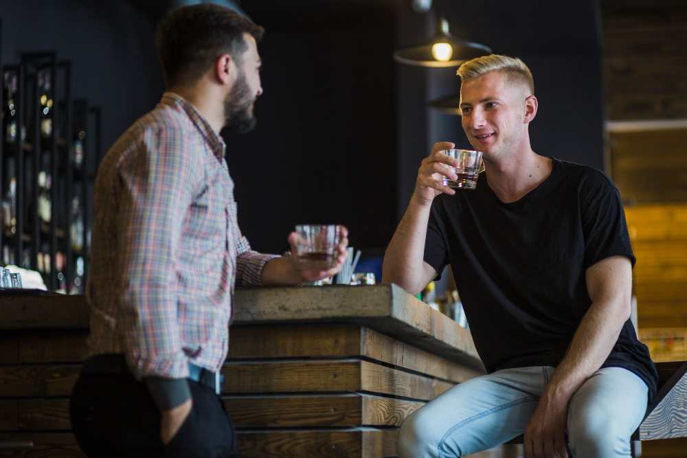 Deux hommes entrain de discuter dans un bar